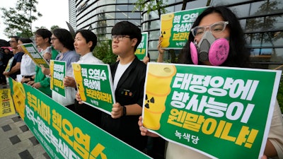 Environmental activists protest against the Japanese government's decision to release treated radioactive wastewater from the wrecked Fukushima nuclear power plant, near a building which houses the Japanese Embassy in Seoul, South Korea, Friday, June 30, 2023.
