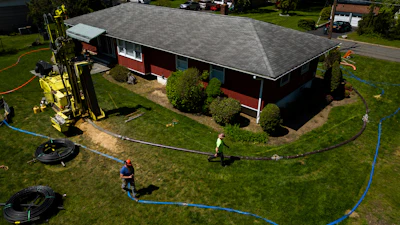 A drill rig for a geothermal heat pump sits outside a home in White Plains, N.Y., Monday, May 8, 2023.