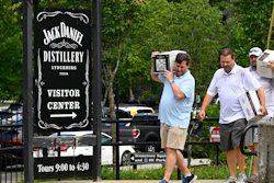 Visitors walk away from the Jack Daniels Distillery visitor center carrying boxes of whiskey Wednesday, June 14, 2023, in Lynchburg, Tenn.