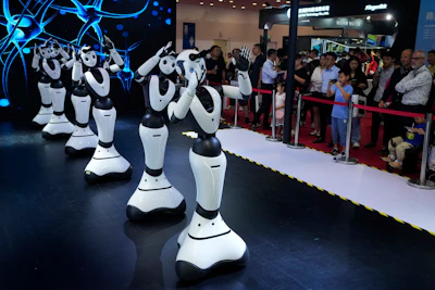 A worker charges robots displayed at the annual World Robot Conference at the Beijing Etrong International Exhibition and Convention Center in Beijing, Wednesday, Aug. 16, 2023.