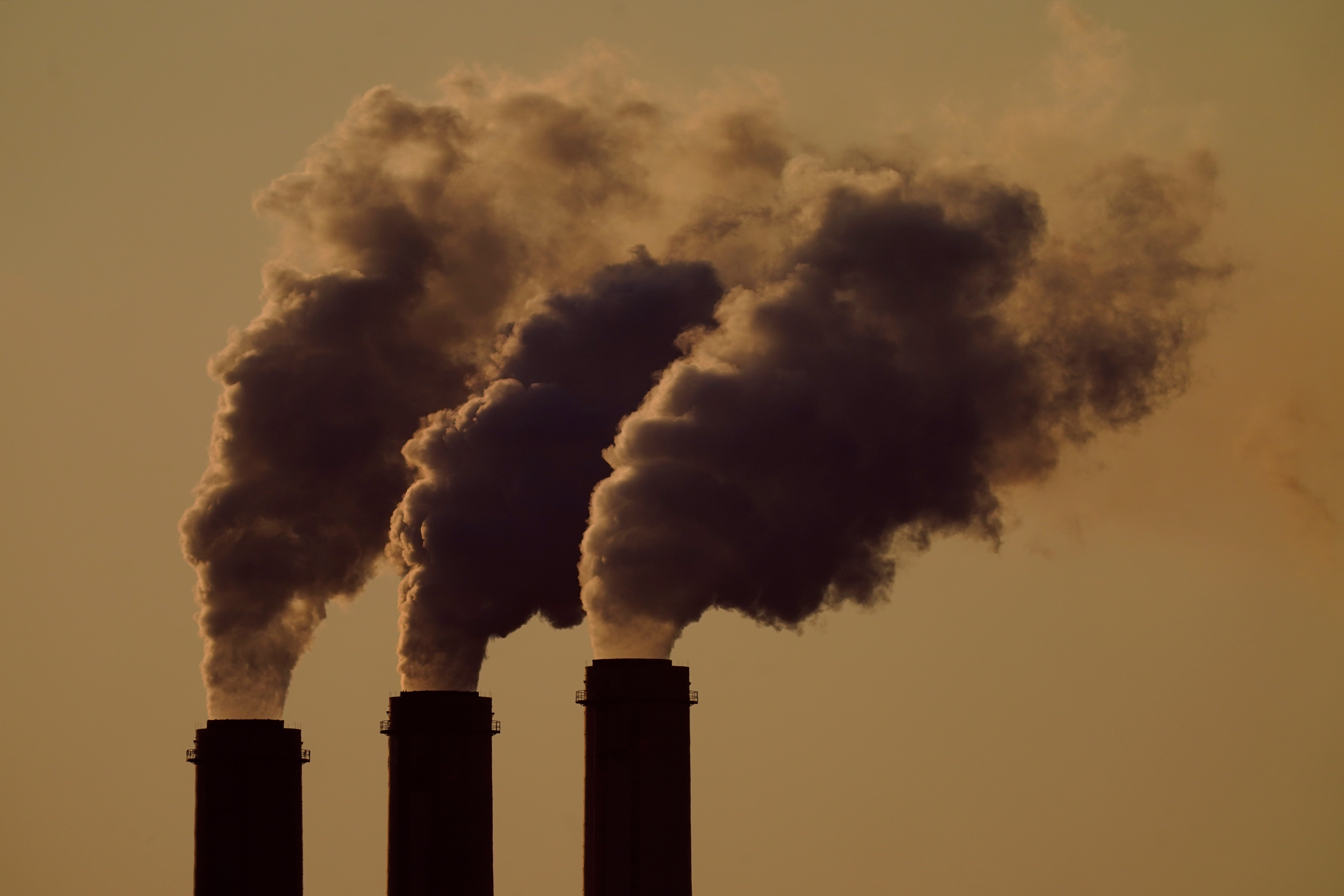 Emissions rise from the smokestacks at the Jeffrey Energy Center coal power plant as the suns sets, near Emmett, Kan., Sept. 18, 2021.