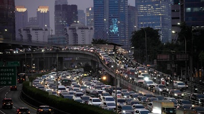 Cars and motorbikes are caught in rush hour traffic at the main business district in Jakarta, Indonesia, Tuesday, Aug. 15, 2023.