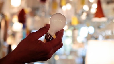 Manager Nick Reynoza holds a 100-watt incandescent light bulb at Royal Lighting in Los Angeles, Jan. 21, 2011. New federal rules governing the energy efficiency of lighting systems went into full effect Tuesday, effectively ending the sale and manufacture of bulbs that trace their origin to an 1880 Thomas Edison patent.
