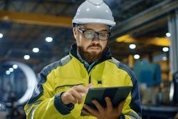 Industrial Engineer In Hard Hat Wearing Safety Jacket Uses Touchscreen Tablet Computer He Works At The Heavy Industry Manufacturing Factory 879814122 5120x2880