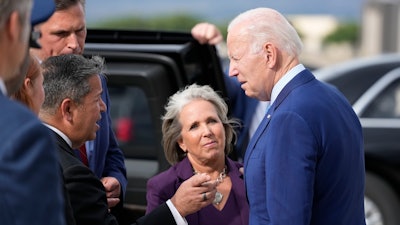 President Joe Biden greets Gov. Lujan Grisham, center, along with Sen. Ben Ray Lujan, D-N.M., and Sen. Martin Heinrich, D-N.M., back left, upon arrival at Kirtland Air Force Base, Tuesday, Aug. 8, 2023, in Albuquerque, N.M.