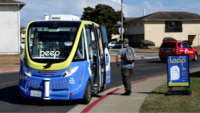 A driverless shuttle stops for a passenger on San Francisco's Treasure Island as part of a pilot program to assess the safety and effectiveness of autonomous vehicles for public transit on Aug. 16, 2023.