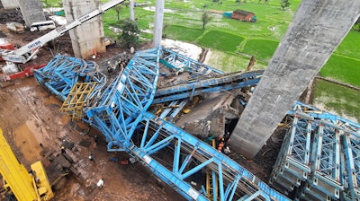 People search among the debris after a huge crane collapsed at a highway construction site at Shahpur Sarlambe village, Thane District, Maharashtra state, India, Tuesday, Aug.1, 2023.