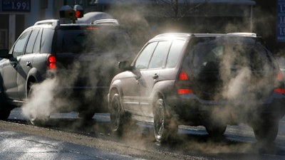 Cars give off exhaust fumes in Montpelier, Vt., Monday, Jan. 26, 2009.
