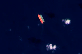 In this satellite photo provided by Planet Labs PBC, vessels identified as the Virgo, left, and the Suez Rajan, by the advocacy group United Against Nuclear Iran, are seen in the South China Sea on Feb. 13, 2022.