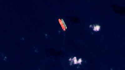 In this satellite photo provided by Planet Labs PBC, vessels identified as the Virgo, left, and the Suez Rajan, by the advocacy group United Against Nuclear Iran, are seen in the South China Sea on Feb. 13, 2022.