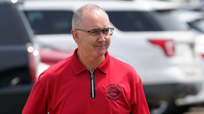 United Auto Workers president Shawn Fain talks with autoworkers outside the General Motors Factory Zero plant in Hamtramck, Mich., July 12, 2023.