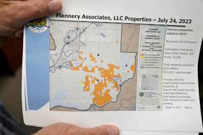 Mayor Ron Kott holds a map showing land acquisitions by Flannery Associates at City Hall in Rio Vista, Calif., Wednesday, Aug. 30, 2023.