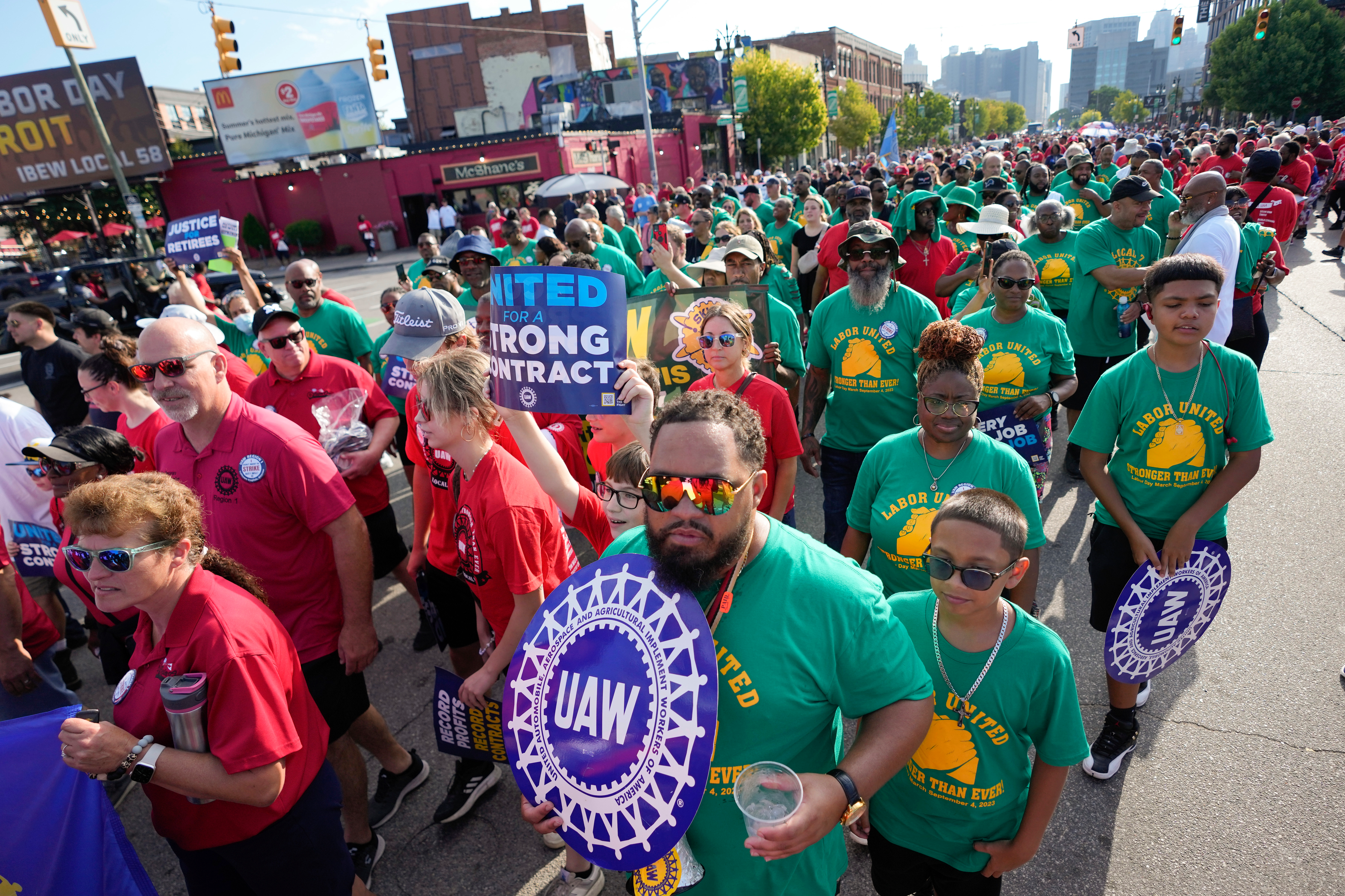 United Auto Workers members walk in the Labor Day parade in Detroit, Monday, Sept. 4, 2023.
