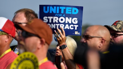 A member holds up a sign at a rally by United Auto Workers Local 863 in Louisville, Ky., on Aug. 24, 2023.