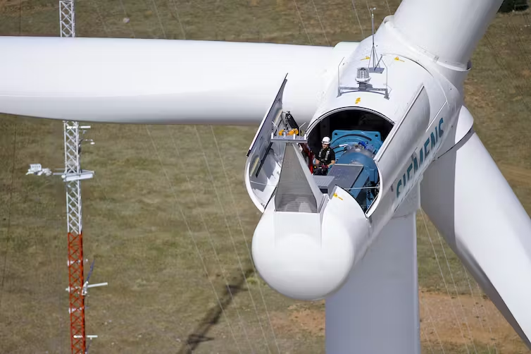 A technician makes adjustments to a wind turbine in Colorado.
