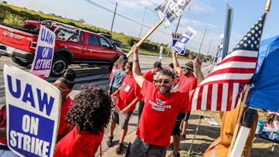 United Auto Workers member Kenneth Carroll, center, of Team 14, dances and cheers on Stickney Avenue outside Stellantis Toledo Assembly Complex on Saturday, Sept. 23, 2023, in Toledo.