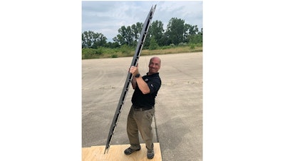 Pablo Zavattieri, the Jerry M. and Lynda T. Engelhardt Professor in Civil Engineering, lifts an aircraft runway mat made with new intelligent architected materials developed at Purdue University.