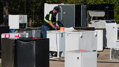 An operator attaches equipment to a used appliance at a customer recovery job site, Monday, Oct. 9, 2023, in Little Elm, Texas.
