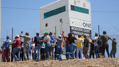Miners gather at the top of a goldmine shaft in Springs, South Africa, Tuesday, Oct. 24, 2023.