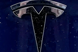 A Tesla electric vehicle emblem is affixed to a passenger vehicle, Feb. 21, 2021, in Boston.