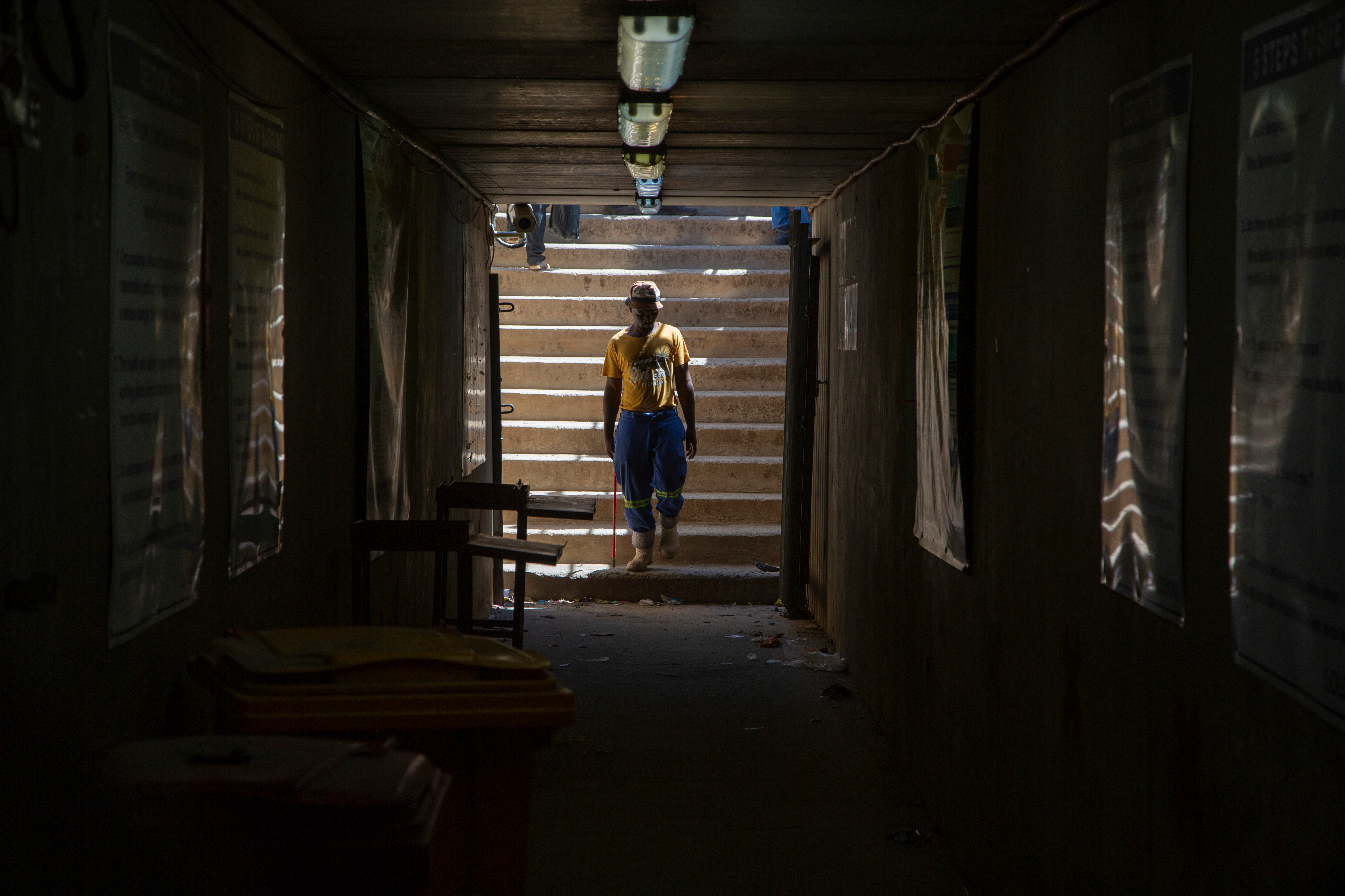 A miner walks at the entrance of a goldmine shaft in Springs, South Africa, Tuesday, Oct. 24, 2023.