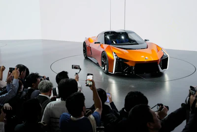 Media members and guests take pictures and film the FT-Se after Toyota Motor Corp. CEO Koji Sato speaks during a briefing on the media day at the Japan Mobility Show in Tokyo, Wednesday, Oct. 25, 2023.