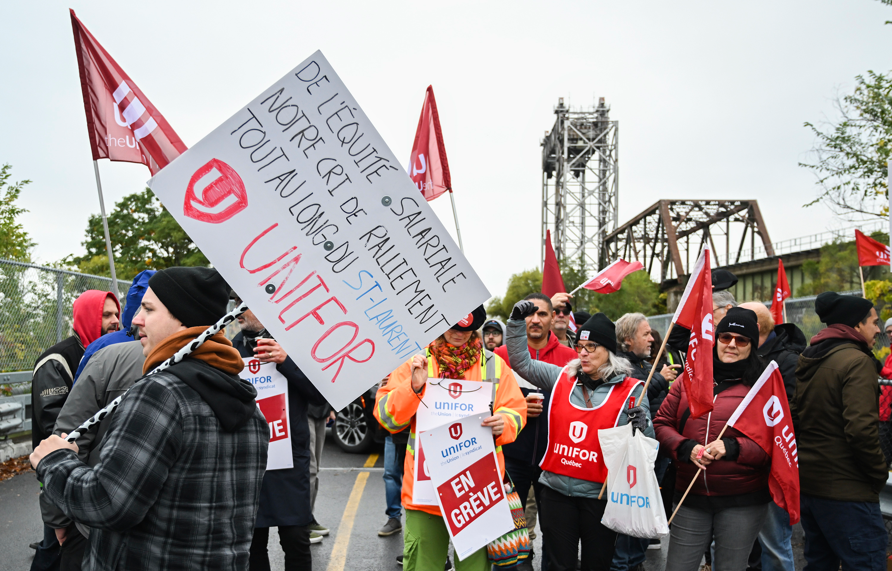 Striking workers picket outside the St. Lambert Lock in St. Lambert, Quebec, Oct. 23, 2023.