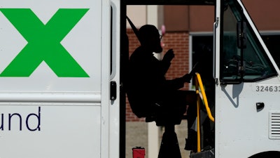 A FedEx driver makes deliveries in Palatine, Ill., Wednesday, Sept. 13, 2023. On Friday, the U.S. government issues its latest monthly jobs report.