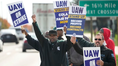 United Auto Workers members walk the picket line during a strike at the Stellantis Sterling Heights Assembly Plant, in Sterling Heights, Mich., Monday, Oct. 23, 2023.