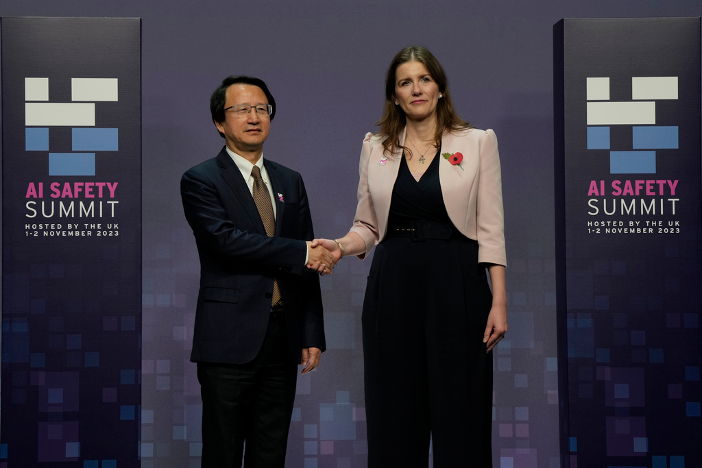 Britain's Michelle Donelan, Secretary of State for Science, Innovation and Technology, right, and Wu Zhaohui, Chinese Vice Minister of Science and Technology, shake hands prior to the AI Saftey Summit in Bletchley Park, Milton Keynes, England, Wednesday, Nov. 1, 2023.