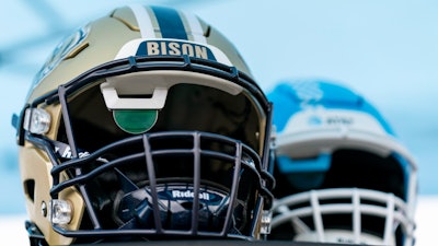 Football helmets that help deaf and hard-of-hearing players see play calls on a lens inside are displayed before an NCAA college football game between the Gallaudet and Hilbert College, Saturday, Oct. 7, 2023, in Washington.