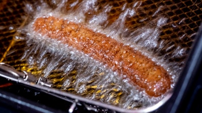 A vegan curry wurst is deep fried in a 'Best Worscht in Town' sausage branch in Frankfurt, Germany, Wednesday, Sept. 13, 2023.