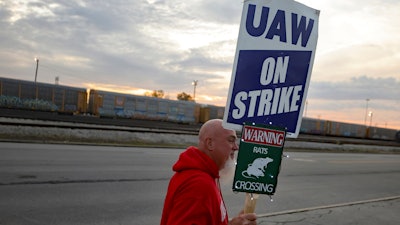 Dan Back, a United Auto Workers Local 12 member, pickets during the ongoing UAW strike at the Stellantis Toledo Assembly Complex on Thursday, Oct. 26, 2023, in Toledo, Ohio. Members of the United Auto Workers union moved closer to approving a contract agreement with Stellantis on Friday, Nov. 17, as two large factories in Detroit voted overwhelmingly for the deal.