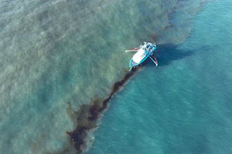 In this photo provided by the U.S. Coast Guard, a Clean Gulf Associates 95-foot response vessel skims crude oil approximately 4 miles southeast off South Pass Louisiana, Friday, Nov. 17, 2023.