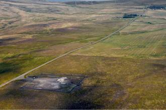 In this image provided by the U.S. Air Force, wind turbines spin near the Malmstrom Air Force Base missile launch site Alpha-03 in Geyser, Mont., in August 2023.