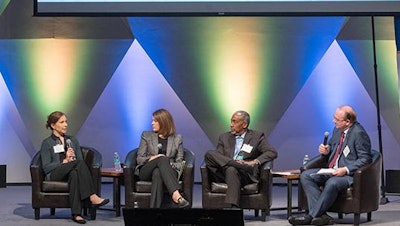 XMO PEI co-chair Stephan Biller (right) leads a panel discussion with industry leaders on building resiliency in U.S. manufacturing and operations.