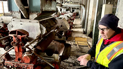 Chris Richmond, president of Moving Pillsbury Forward, explains the machine that grounds wheat into flour on the fourth floor of the AB-Mill, the former heart of the operation at the vacant Pillsbury Mills in Springfield, Ill., Nov. 30, 2023.
