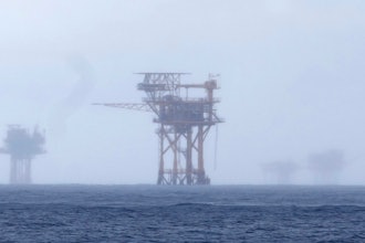 Oil platforms are visible through the haze near the Flower Garden Banks National Marine Sanctuary in the Gulf of Mexico, off the coast of Galveston, Texas, Sept. 16, 2023. Oil companies offered $382 million for drilling leases in the Gulf Wednesday after courts rejected the Biden administration's plans to scale back the sale to protect an endangered whale species.