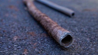 Lead water pipes pulled from underneath the street are seen in Newark, N.J., Oct. 21, 2021.