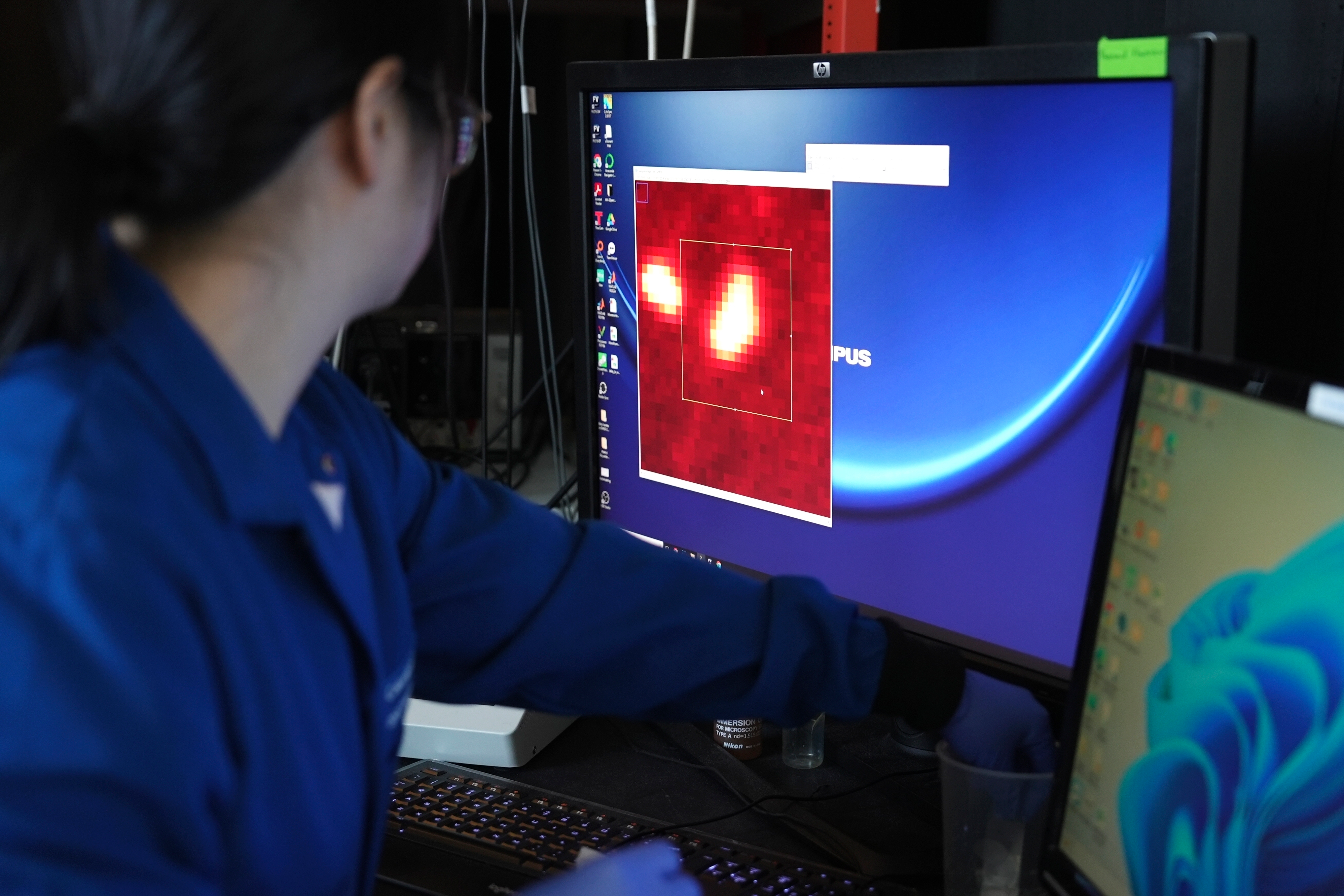 Columbia chemist Naixin Qian zooms in on an image generated from a microscope scan, New York, Jan. 8, 2024.