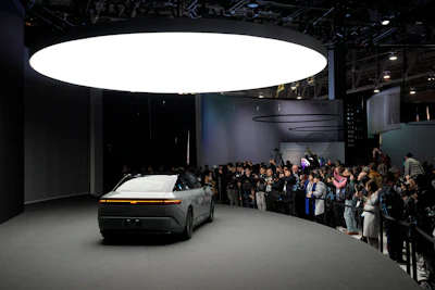 People take pictures of an Afeela EV during a Sony press conference ahead of the CES tech show Monday, Jan. 8, 2024, in Las Vegas.