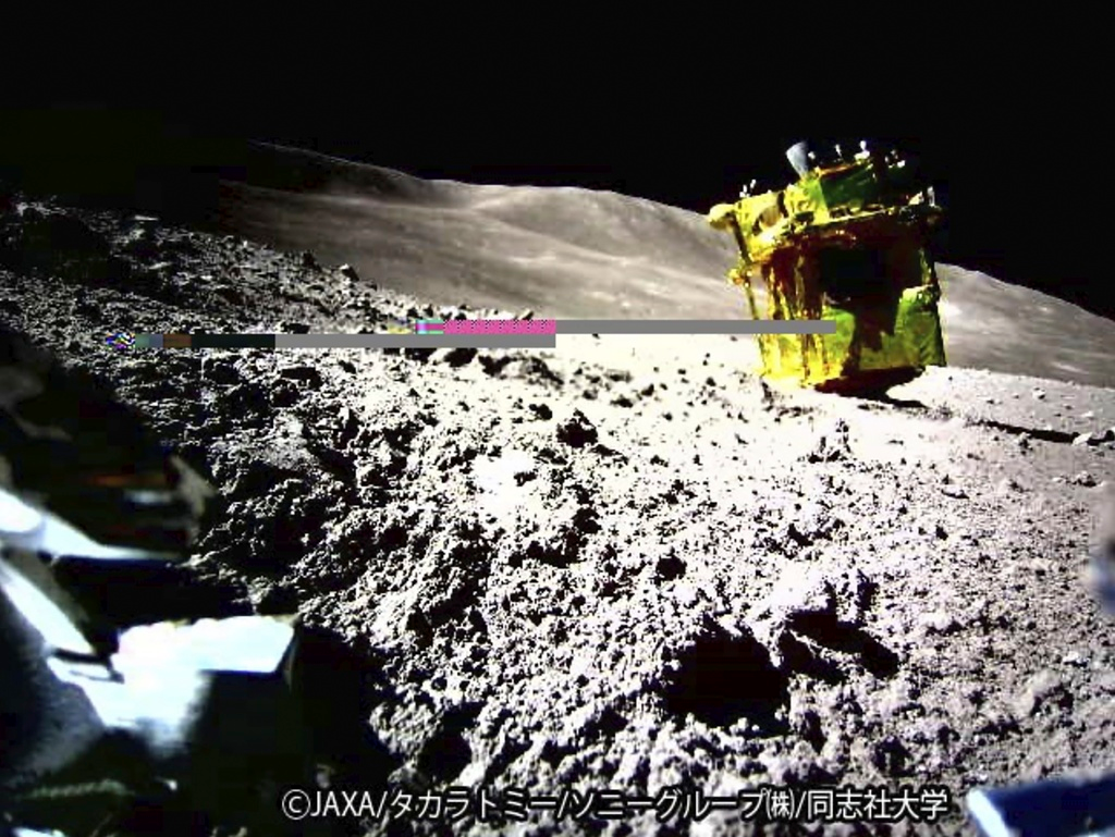 This image shows an image taken by a Lunar Excursion Vehicle 2 (LEV-2) of a robotic moon rover called Smart Lander for Investigating Moon, or SLIM, on the moon.