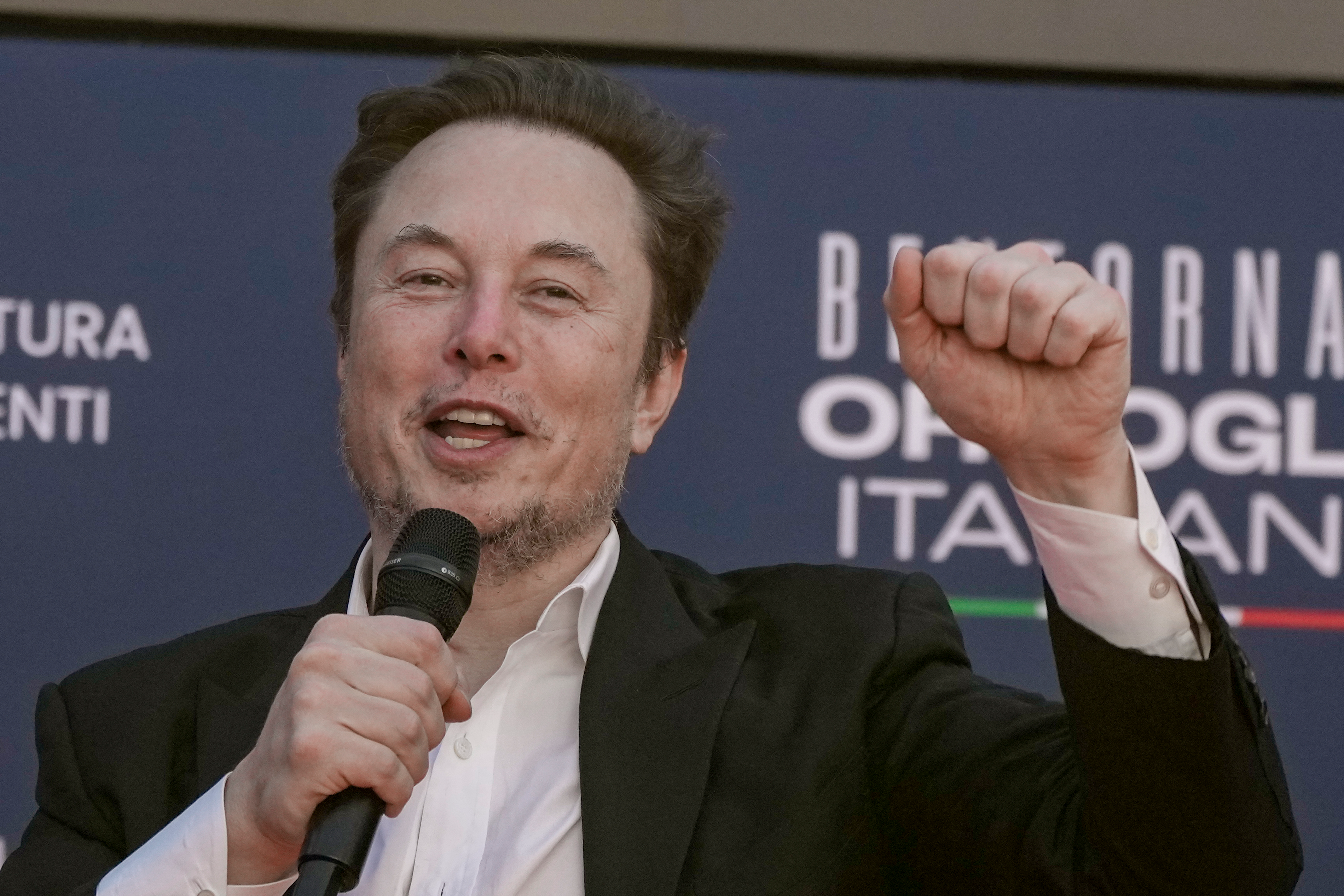 Tesla CEO Elon Musk waves as he arrives at the annual political festival Atreju, organized by the Giorgia Meloni's Brothers of Italy political party, in Rome, Dec. 16, 2023.