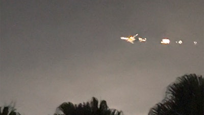 This image taken from video provided by Melanie Adaros shows sparks shooting from a cargo plane before making an emergency landing at Miami International Airport on Thursday, Jan. 18, 2024 in Miami.