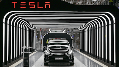 Model Y electric vehicles stand on a conveyor belt at the opening of the Tesla factory in Berlin Brandenburg in Gruenheide, Germany, Tuesday, March 22, 2022. Tesla production stands still because of The armed conflicts in the Red Sea and the associated shifts in transport routes between Europe and Asia.