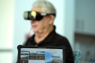 A screen displays a visual of being in a Navy fighter jet as retired Army Col. Farrell Patrick, 91, wears a Mynd Immersive virtual reality headset at John Knox Village, Wednesday, Jan. 31, 2024, in Pompano Beach, Fla.