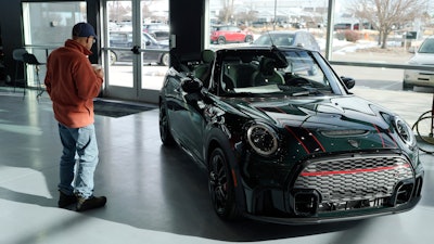 A man looks at a 2024 Cooper S John Cooper Works convertible at a Mini dealership on Nov. 30, 2023, in Loveland, Colo.