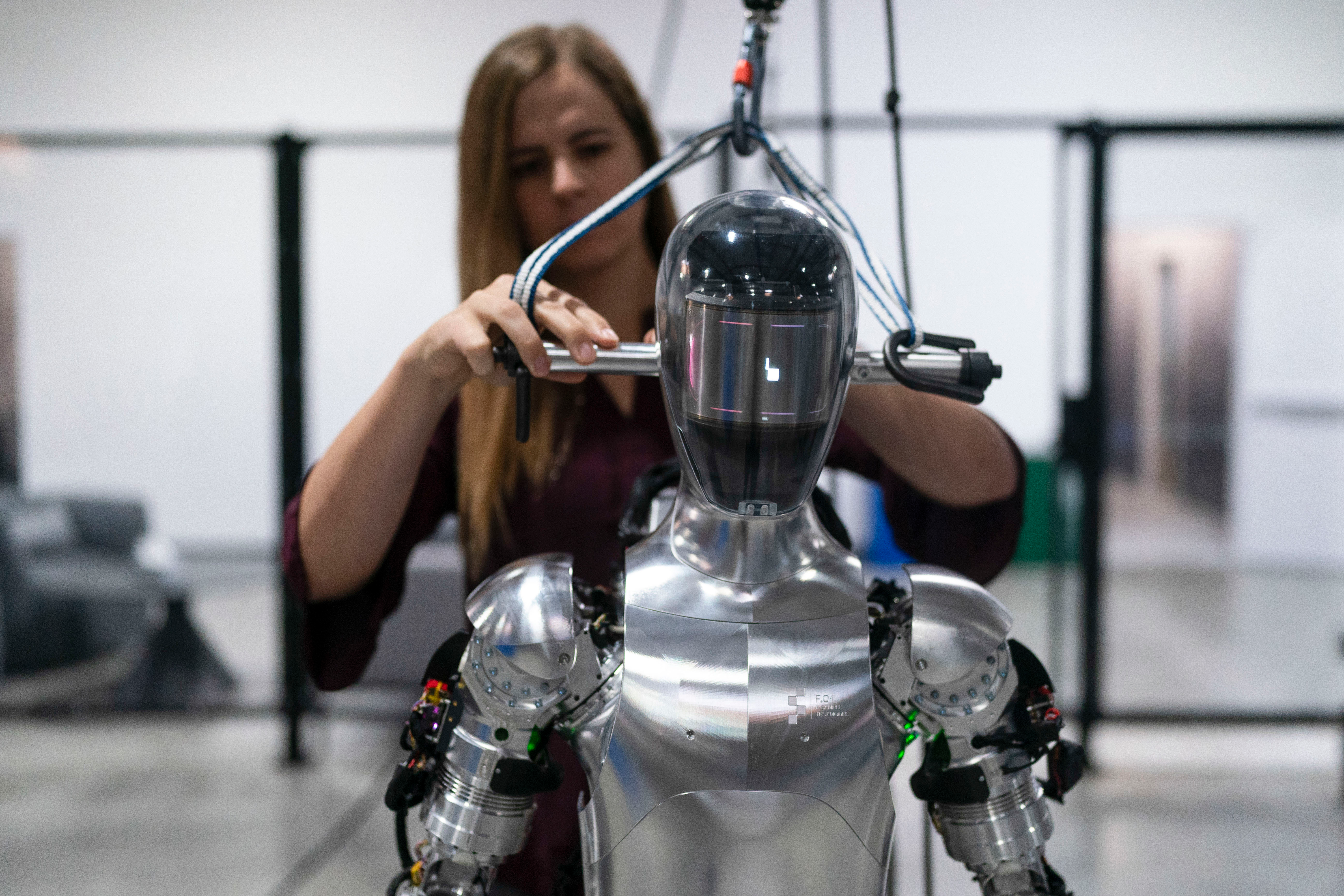 AI engineer Jenna Reher works on humanoid robot Figure 01 at Figure AI's test facility in Sunnyvale, Calif., Oct. 3, 2023.