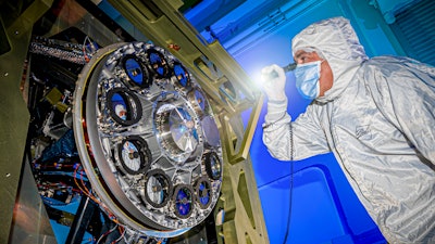 A Ball Aerospace specialist inspects components of the Nancy Grace Roman Space Telescope.