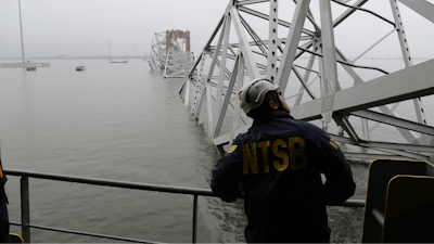 An NTSB official examines the Francis Scott Key Bridge in Baltimore.